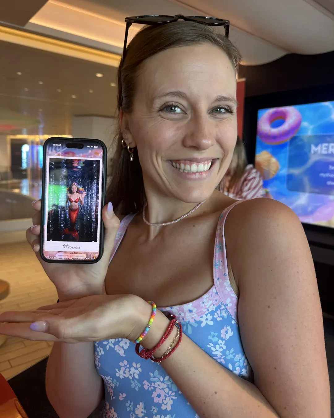 A guest holding up her phone to show the portrait Photoworld generated for her