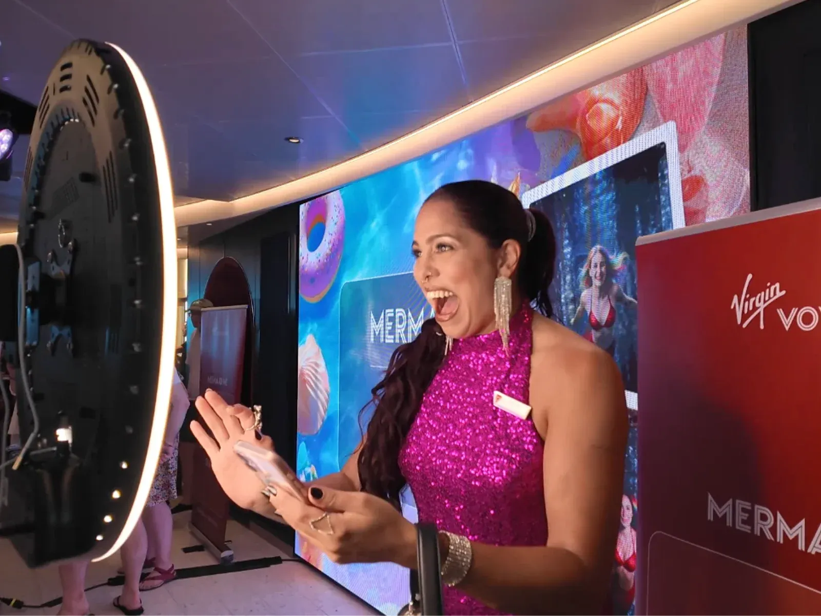 A guest at a permanent Photoworld installation built into a venue's branded screen wall